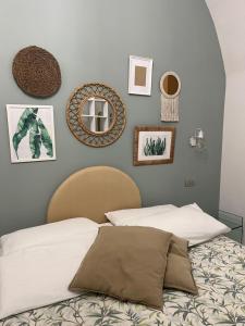 a bedroom with a bed and some pictures on the wall at LOFT 13 in Maiori