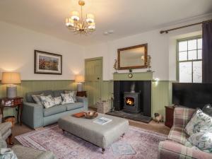 a living room with a couch and a fireplace at Glen Cottage - Torridon in Achnasheen