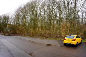 a yellow car parked on the side of a road at GN Hotel Furpach in Neunkirchen