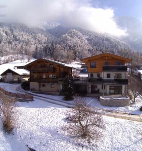 a large building in the snow with a mountain at Apartment im Greit in Oetz