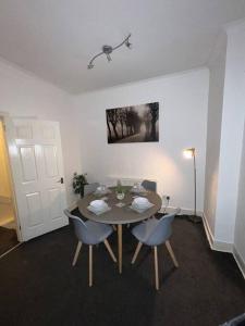 a dining room with a table and two chairs at Comfortable and spacious home. FREE Parking. in Gateshead