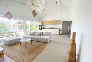 a living room with a couch and a table at Villa du Levant-6/8 pers-Piscine in Saint-François