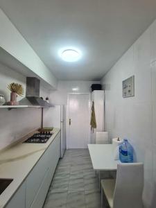 a kitchen with white cabinets and a white counter top at Nice beachside 2-BD apt near Barcelona in Cunit +38 photos
