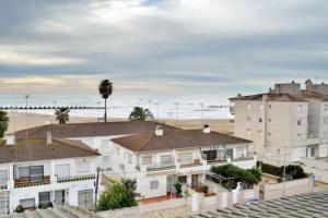 a group of houses with the ocean in the background at Nice beachside 2-BD apt near Barcelona in Cunit