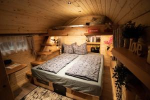 a bedroom with a bed in a wooden room at Röhrencamp Schöten/Apolda in Apolda