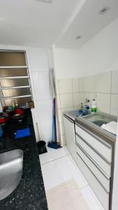 a small kitchen with a sink and a counter at Apartamento Home Pratice in São Luís