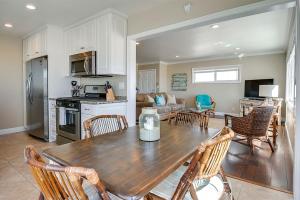 uma cozinha e sala de estar com uma mesa de madeira e cadeiras em Beachfront Getaway on the Sand em Newport Beach