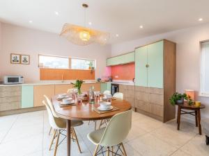 a kitchen and dining room with a wooden table and chairs at 3 Bed in Braunton 86042 in Braunton