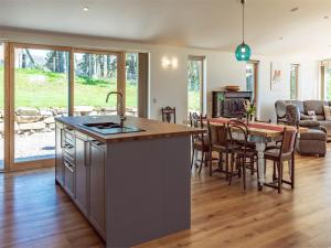 a kitchen and living room with a table and chairs at 4 Bed in Grantown on Spey CA027 in Grantown on Spey