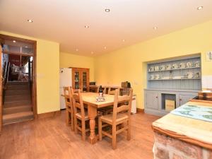 a kitchen with a wooden table and chairs at 4 Bed in Whaley Bridge PK534 in Whaley Bridge