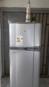 a white refrigerator with a sign on top of it at Hospedaje entre rokas in Huasco