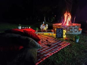 a fire pit with a sign in front of it at Rancho San Miguel in Villa del Carbón