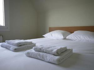 a white bed with towels on top of it at CHEZ LEO: T2,cosy,metro in Rennes