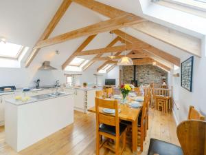 a kitchen and dining room with a table and chairs at 3 Bed in Newquay 89941 in Mawgan Porth