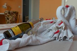 GuestHouse Martin في روما: زجاجة من النبيذ ومناشف على السرير