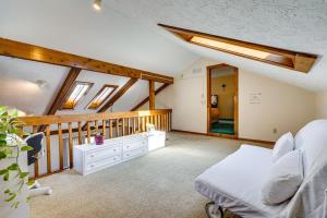a attic bedroom with a bed and a staircase at Spacious Ohio Home about 12 Mi to Downtown Columbus in Worthington