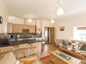 a large living room with a couch and a kitchen at 1 Bed in Edzell CA335 in Edzell