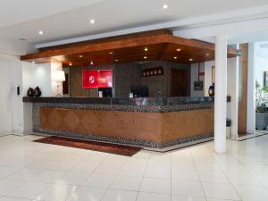 a lobby with a bar in a building at Carlton Suítes Limeira in Limeira