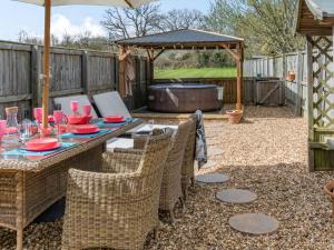 a patio with a table and chairs and a grill at 2 bed property in Bradford-on-Avon 87056 in Southwick