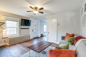 a living room with a couch and a ceiling fan at Historic Yardley Retreat - 1 Block to the River! in Yardley