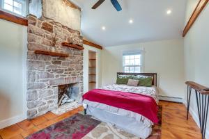 um quarto com uma lareira de pedra e uma cama em Historic Yardley Retreat - 1 Block to the River! em Yardley