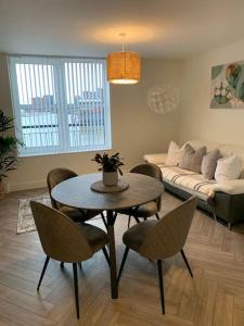 a living room with a table and chairs and a couch at Waterfront view apartment in Lincolnshire
