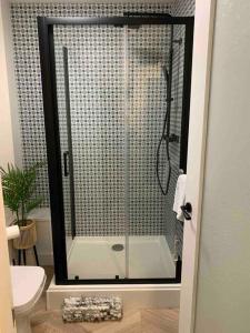 a shower with a glass door in a bathroom at Waterfront view apartment in Lincolnshire