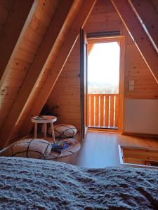 a attic room with a bed and a window at Glamping Čelig 