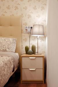 ein Schlafzimmer mit einem Bett und einer Lampe auf einem Nachttisch in der Unterkunft ConIDE APARTAMENTO 3 DORMITORIOS in Oviedo