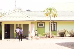 zwei Männer stehen vor einem Haus in der Unterkunft Royal Suites And Apartments Lugbe, Abuja 