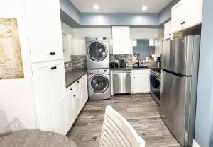 a kitchen with stainless steel appliances and white cabinets at The Creek Retreat - Totally private 1Br/1Bd 