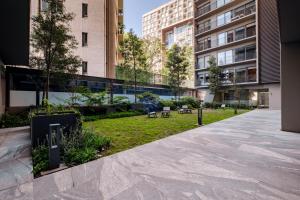 a park in the middle of a city with buildings at Lumina at Taman Condesa in Mexico City +52 photos