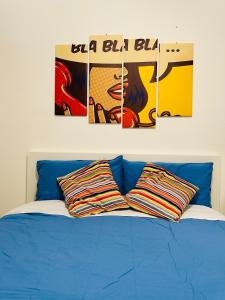 a blue couch with two posters on the wall at La casa del fumetto in Castel di Sangro