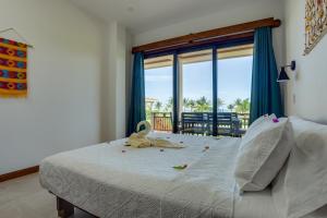 a bedroom with a bed with a view of the ocean at Seiri del Mar in Hopkins +241 photos