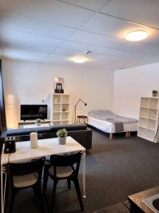 Habitación con sofá, cama y mesa. en Rentalux Apartments at Vivansborg, en Timrå