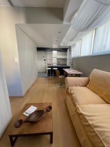 ein Wohnzimmer mit Sofa und Tisch in der Unterkunft Departamento Facultades in Buenos Aires