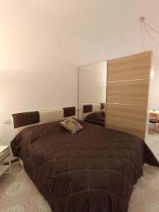 a bedroom with a large bed and a large mirror at Piazza Ansidei in Perugia