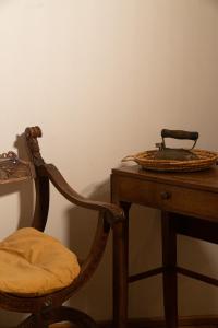 a chair next to a table with a basket on it at Agriturismo Barchessa in Este