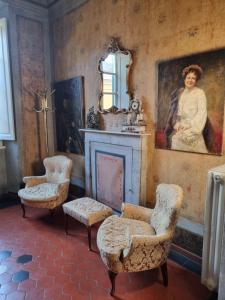 a living room with a portrait of a woman on the wall at il Pozzo Apartment in Città di Castello