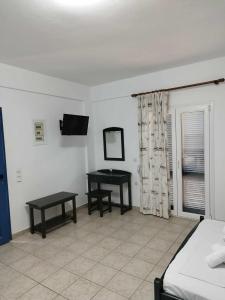a bedroom with a bed and two tables in it at Ο Μήλας in Agios Dimitrios
