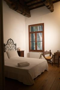 a bedroom with a white bed and a window at Agriturismo Barchessa in Este