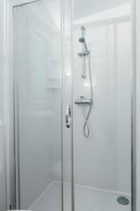 a shower with a glass door in a bathroom at San Antonio mobile homes in Biograd na Moru +52 photos