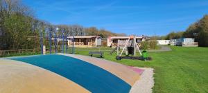 a park with a playground with a swing at Camping de Ikeleane in Bakkeveen
