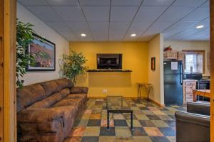 a living room with a brown couch and a kitchen at Appalachian House Downtown Boone ON King Street in Boone