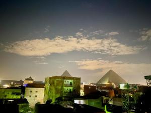 a view of the pyramids in a city with buildings at Studio Merit Pyramids View in Cairo