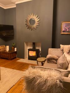 a living room with a couch and a fireplace at Specious City Victorian House in Plymouth