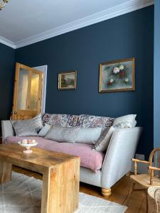 a living room with a couch and a table at Specious City Victorian House in Plymouth