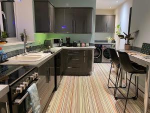 a kitchen with a sink and a counter top at Specious City Victorian House in Plymouth