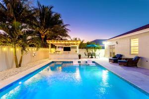 a swimming pool in the backyard of a house at Lux Backyard/Heated Pool/Everglades/Speedway/Keys! in Miami