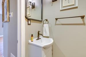 a bathroom with a sink and a mirror at Quaint Kingsport Apartment Near Greenbelt Trail! in Kingsport +22 photos
